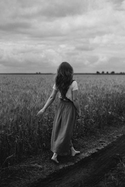A woman walking through a field