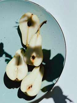 A plate with three pears on it