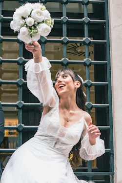 A bride is holding her bouquet in her hand