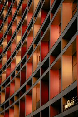 A striking facade in Taipei, featuring curved architectural lines and red-toned panels.