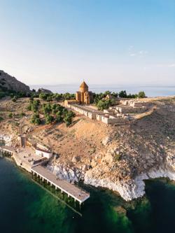 A stunning aerial shot of Akdamar Island with the historic church surrounded by the beautiful Lake Van.