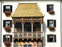 The historic Golden Roof in Innsbruck's old town, showcasing ornate architecture and floral decoration.